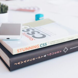 white smartphone on two softbound books